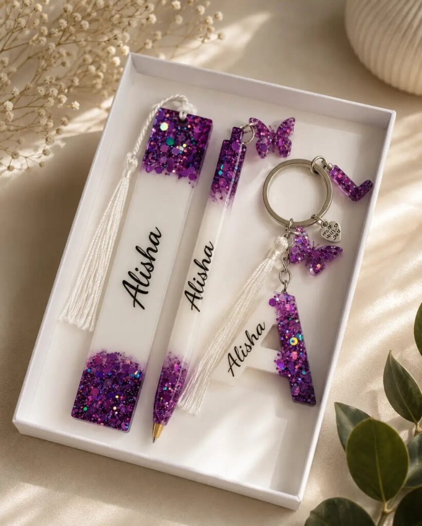 Personalized resin bookmark, pen, and keychain with purple glitter and the name Alisha.