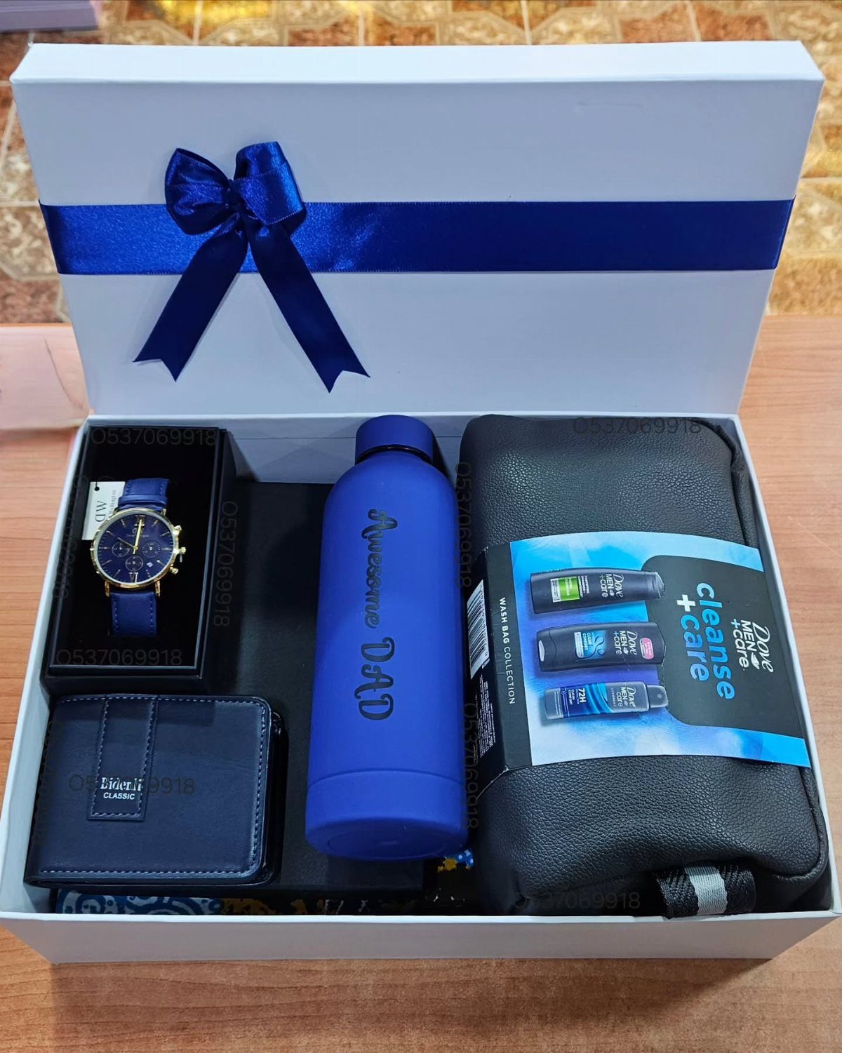 Blue themed gift set for dad in a white box with ribbon.
