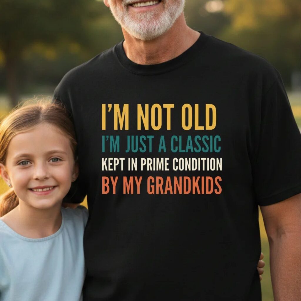 Older man wearing a black t-shirt with a funny quote about grandkids.