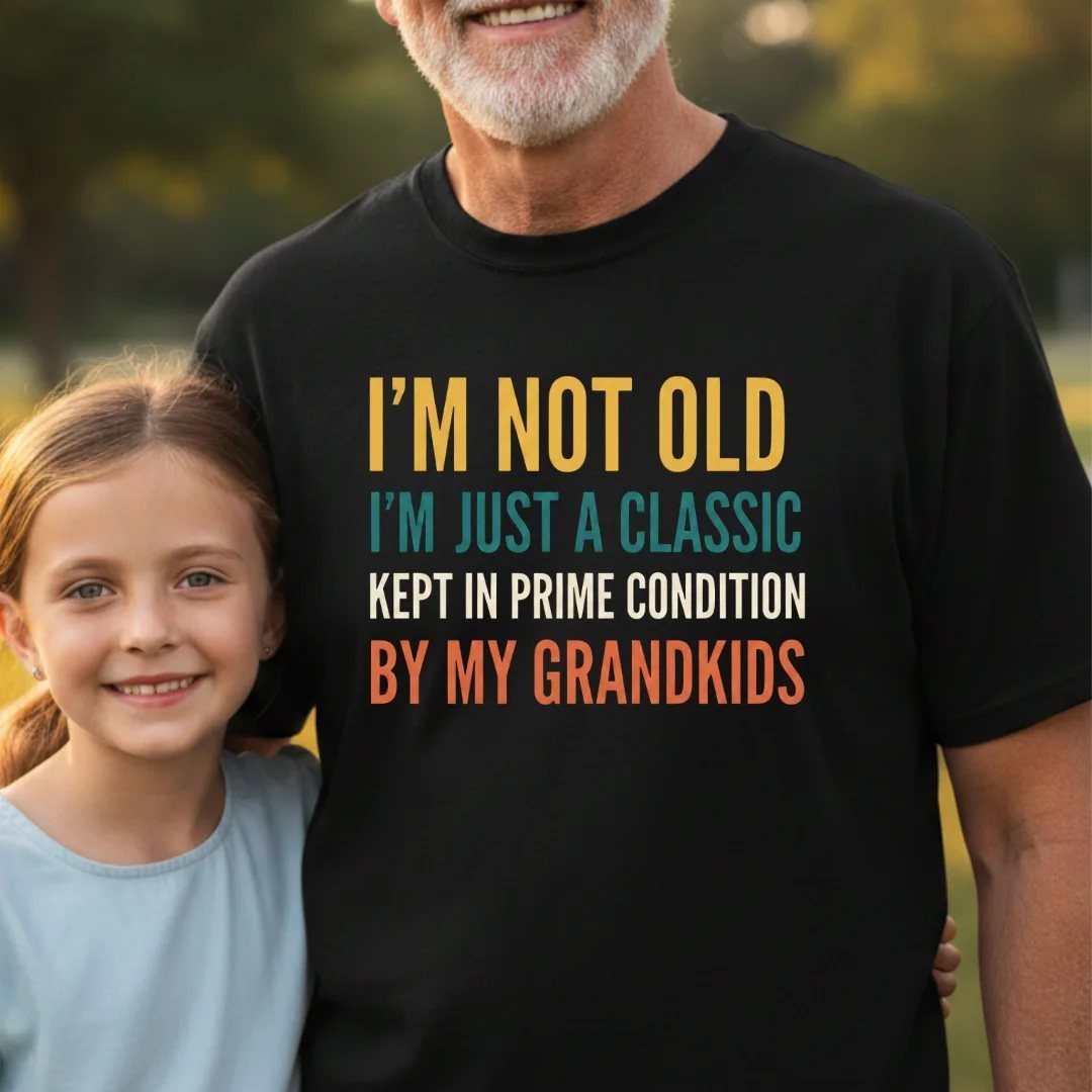 Older man wearing a black t-shirt with a funny quote about grandkids.