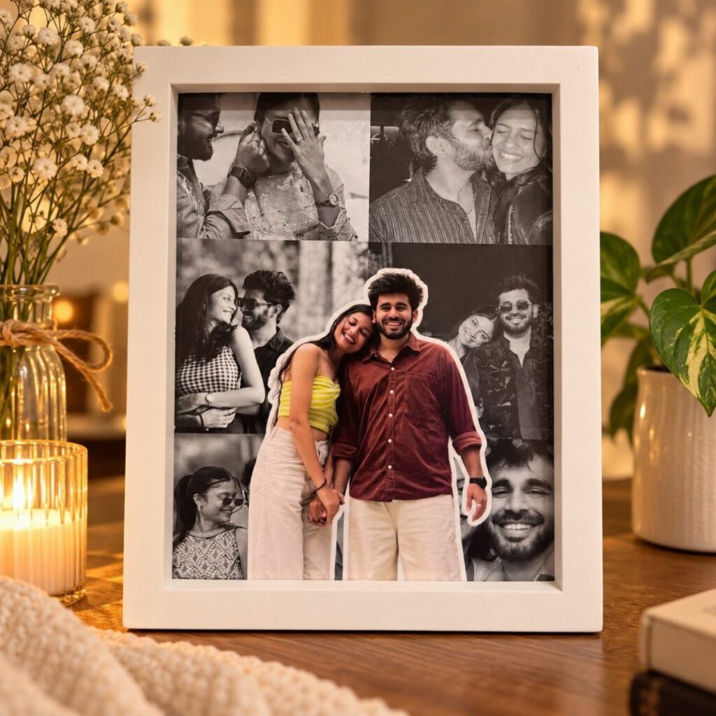 White photo frame containing a collage of couple photos on a wooden table.