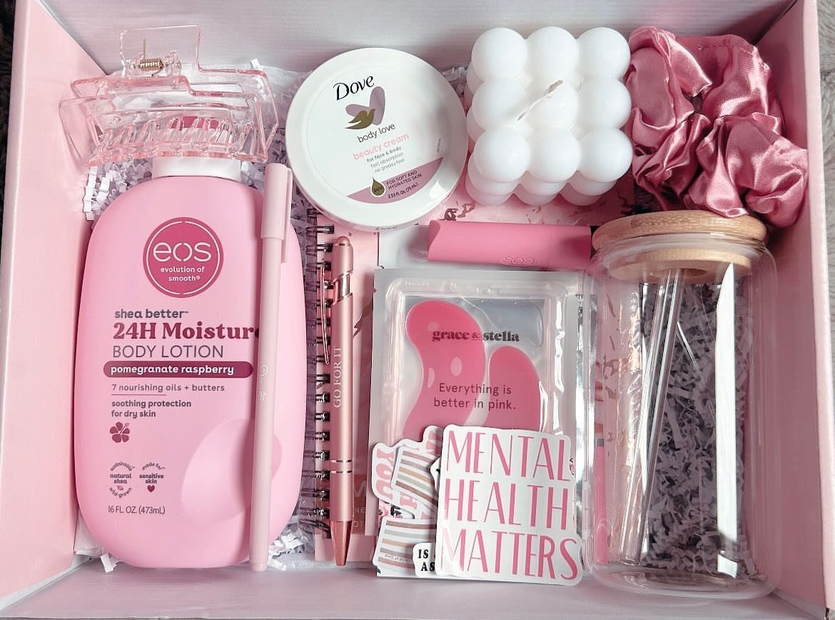 Pink gift box filled with body lotion, scrub, bubble candle, and wellness accessories.