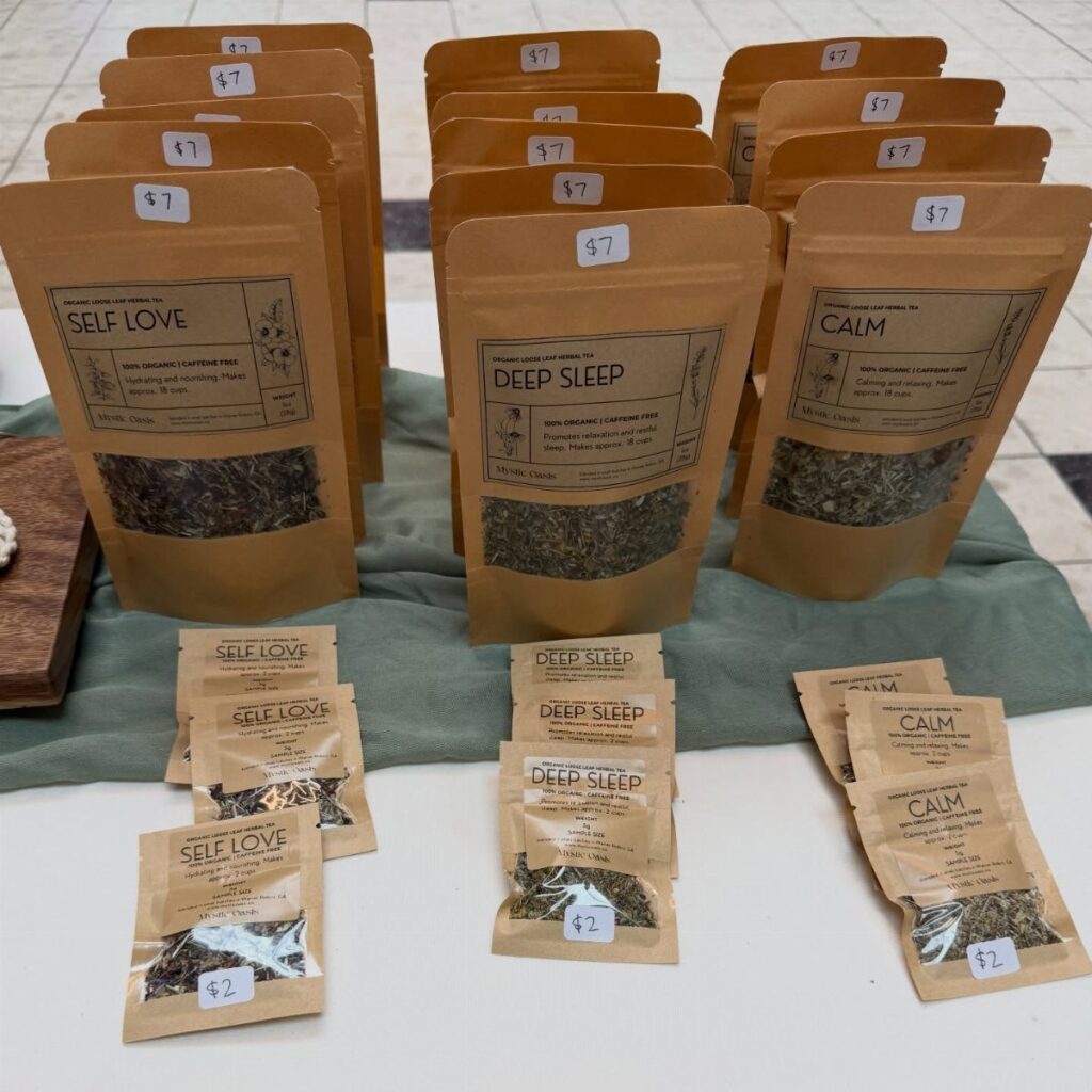 Brown paper tea pouches labeled Self Love, Deep Sleep, and Calm on white surface.